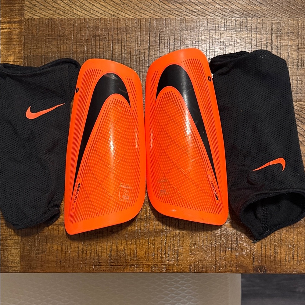 Nike Bright Orange Shin Guards with Black Sleeves